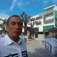 a man stands in front of a building that has the word center on the top