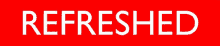 a red sign that says " refreshed " in white letters