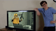 a man stands in front of a flat screen tv that says cope