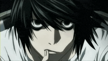 a close up of a person 's face with a finger on their mouth .
