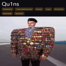 a man is covered in medals and ribbons and has the word qu1ns on the bottom