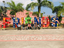 a group of people are posing in front of a large sign that says friends