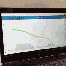 a laptop screen shows a graph and the words " your portfolio "