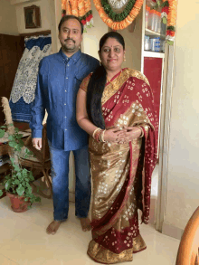 a man and woman are posing for a picture in a room