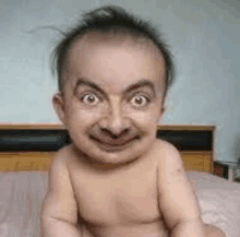 a baby with a mr bean face is sitting on a bed .