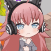 a girl with pink hair and cat ears wearing headphones .