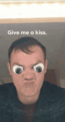 a man is making a funny face with googly eyes and the words give me a kiss