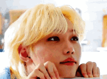 a close up of a person 's face with blonde hair and red lips .