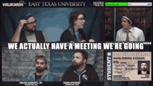 a group of people are sitting in front of a brick wall and a sign that says east texas university