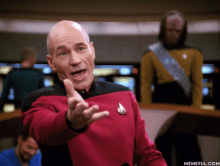 a man in a star trek uniform is pointing his finger at the camera