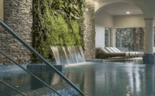 a swimming pool with a waterfall in the middle