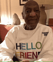 a man wearing a white shirt that says hello friend on it