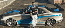 a man standing next to a car that says gtr