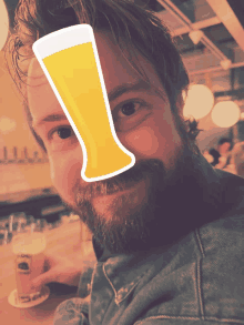 a man with a beard is holding a cup of beer