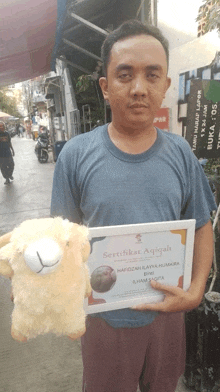 a man holding a certificate and a stuffed sheep