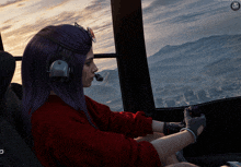 a woman with purple hair is sitting in the cockpit of a helicopter looking out the window