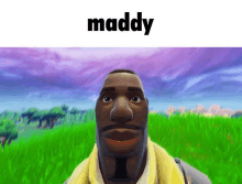 a man with a beard is standing in a field with the word maddy above him