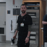 a man wearing a name tag that says doctor on it