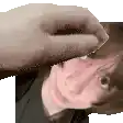 a hand is touching a woman 's forehead in a pixelated image .