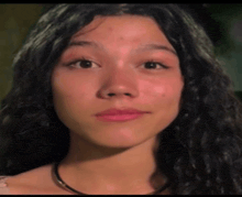 a close up of a woman 's face with long dark hair