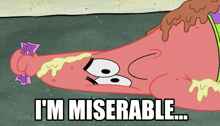 a cartoon of patrick star laying on the ground with the words i 'm miserable