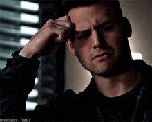 a close up of a man 's face with a tear running down his face