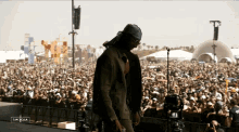 a man stands in front of a crowd at a music festival with a caption that says " cancela "