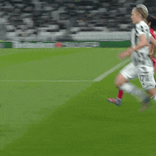 a soccer player with the number 1 on his shirt is kicking the ball
