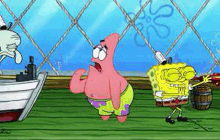 patrick star from spongebob squarepants is standing next to spongebob and squidward .