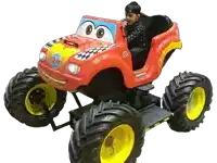 a boy sits in a red monster truck with the number 27 on the side