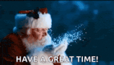 santa claus blowing snow in the air with the words have a great time