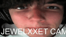 a close up of a person 's face with the words jewelxxet cam on the bottom