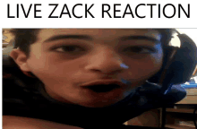 a picture of a man with his mouth open and the words live zack reaction below him