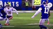 a football player with the number 36 on his jersey is running on the field
