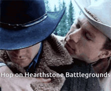 two men in cowboy hats are hugging each other with the words hop on hearthstone battlegrounds written on the bottom