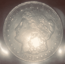 a silver coin from 1921 has a woman 's face on it