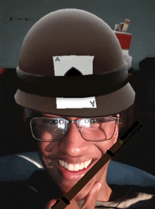 a man wearing glasses and a helmet with a sticker that says ' a ' on it