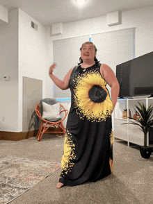 a woman in a black dress with a sunflower on it