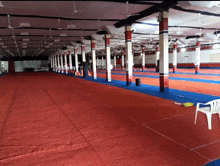 a large empty room with red and blue carpets