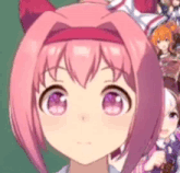 a close up of a pink anime girl 's face with a blurred background .