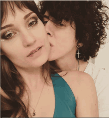 a woman kissing another woman on the cheek