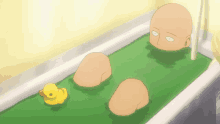 a bald man is laying in a bathtub with a rubber duck next to him