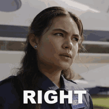 a woman in a medical uniform stands in front of an airplane and the word right is above her head