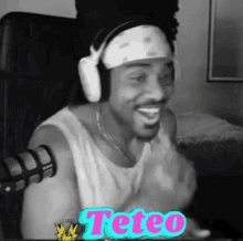 a black and white photo of a man wearing headphones and a bandana with the word teteo on it