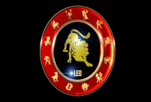 a lion is in the center of a red circle with other zodiac signs .