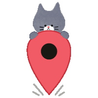 a cat is holding a red pin with a black circle in the middle