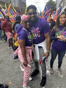 a man and a woman are posing for a photo while wearing shirts that say always proud