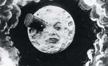 a black and white drawing of a face on the moon