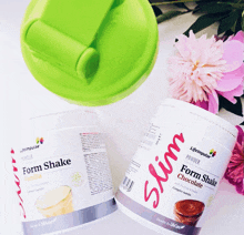 a bottle of slim form shake chocolate next to a green shaker