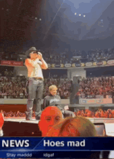 a man in a cowboy hat is standing on a stage in front of a crowd with the words news hoes mad